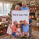 Grandparents holding a personalized 3D blanket that says Nana and Papa's Crew on Christmas morning, grandkids next to them